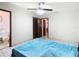 Bedroom with teal bedding, ceiling fan, and ensuite bathroom access at 5316 Buttonwood Dr, New Port Richey, FL 34652