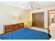 Bedroom with blue bedding, wood furniture, and sliding closet doors at 5316 Buttonwood Dr, New Port Richey, FL 34652