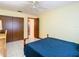 Bedroom featuring blue bedspread, ceiling fan, and closet at 5316 Buttonwood Dr, New Port Richey, FL 34652