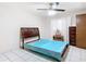 Cozy bedroom with teal bedding and ceiling fan at 5316 Buttonwood Dr, New Port Richey, FL 34652