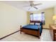 Simple bedroom with wood bedframe, blue bedding, and ceiling fan at 5316 Buttonwood Dr, New Port Richey, FL 34652
