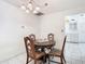 Dining area with round wooden table and chairs, adjacent to the kitchen at 5316 Buttonwood Dr, New Port Richey, FL 34652