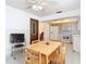 Kitchen with dining table, white cabinets, and ceiling fan at 5316 Buttonwood Dr, New Port Richey, FL 34652