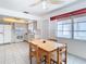 Bright kitchen with white cabinets, dining area, and ceiling fan at 5316 Buttonwood Dr, New Port Richey, FL 34652