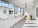 Sunroom with large windows, tile floor, and ceiling fan at 5316 Buttonwood Dr, New Port Richey, FL 34652