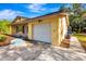 Side view of the single-story home highlighting the garage and stone accents at 5416 Isabella Ave, Sarasota, FL 34235