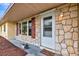 Welcoming front entrance with stone accents, red shutters, and a covered porch at 5416 Isabella Ave, Sarasota, FL 34235