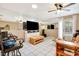 Living room featuring a large wall mirror, tile floors, and a ceiling fan at 5416 Isabella Ave, Sarasota, FL 34235