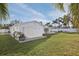 Backyard with white fence, palm trees, and a detached garage or shed at 6459 30Th N Ave, St Petersburg, FL 33710