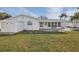 View of the backyard featuring a patio, storage shed, and green lawn at 6459 30Th N Ave, St Petersburg, FL 33710