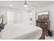 Main bedroom featuring a ceiling fan, large bed, and a TV mounted on a dresser at 6459 30Th N Ave, St Petersburg, FL 33710