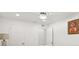 Bright, minimalist bedroom with white walls and a religious art piece at 6459 30Th N Ave, St Petersburg, FL 33710