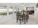 Dining room with dark wood table and chairs, white tile floor, and bright windows at 6459 30Th N Ave, St Petersburg, FL 33710