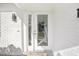 Modern white front door with glass panels and a white brick exterior at 6459 30Th N Ave, St Petersburg, FL 33710