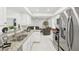 Modern kitchen with white cabinets, stainless steel appliances, and speckled granite countertops at 6459 30Th N Ave, St Petersburg, FL 33710