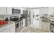 Modern white kitchen with stainless steel appliances, granite countertops, and ample storage at 6459 30Th N Ave, St Petersburg, FL 33710