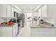 Long galley kitchen with white shaker cabinets, stainless steel appliances, and granite countertops at 6459 30Th N Ave, St Petersburg, FL 33710