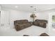 Bright living room with two brown couches and white tile floors at 6459 30Th N Ave, St Petersburg, FL 33710
