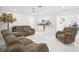Open concept living room with brown furniture and a view of the kitchen at 6459 30Th N Ave, St Petersburg, FL 33710