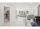 Open concept living room with white tile floors, view of kitchen and large windows at 6459 30Th N Ave, St Petersburg, FL 33710