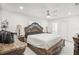 Spacious main bedroom with wooden furniture, ceiling fan, and ensuite bathroom access at 6459 30Th N Ave, St Petersburg, FL 33710