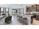 Open-concept kitchen and living area with dark wood cabinets, granite countertops, and an island with bar seating at 704 160Th E Ln, Bradenton, FL 34212
