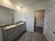 Bathroom with double sink vanity, granite counters, and walk-in closet at 8379 Ender Hills Dr, Wesley Chapel, FL 33545