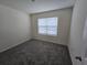 Empty bedroom with neutral walls, carpeted floors, and window with blinds at 8379 Ender Hills Dr, Wesley Chapel, FL 33545