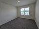 Empty bedroom with neutral walls, carpeting, and window with blinds at 8379 Ender Hills Dr, Wesley Chapel, FL 33545