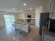 Open concept kitchen with island, dining area, and view of the backyard at 8379 Ender Hills Dr, Wesley Chapel, FL 33545