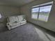 Living room with white leather reclining loveseat, large window, and view of the water at 8379 Ender Hills Dr, Wesley Chapel, FL 33545