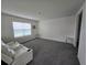 Spacious living room with carpeted flooring, white walls, and two end tables at 8379 Ender Hills Dr, Wesley Chapel, FL 33545