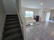 Living area with white sofa, stairs to the second floor at 8379 Ender Hills Dr, Wesley Chapel, FL 33545