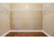 Spacious walk-in closet with wire shelving and wood flooring at 10763 Standing Stone Dr, Wimauma, FL 33598