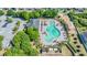 Community pool and surrounding areas, including parking and playground at 10763 Standing Stone Dr, Wimauma, FL 33598