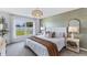 Spacious main bedroom with a comfortable bed and green accent wall at 10903 Gentle Current Way, Parrish, FL 34219