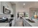 Modern kitchen with stainless steel appliances, white countertops, and ample cabinet space at 12696 Tannencrest Dr, Riverview, FL 33579