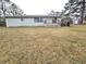 Home's back elevation and expansive grassy yard at 16213 Fiscus Dr, Spring Hill, FL 34610