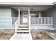 Covered front porch with white railing and front door at 16213 Fiscus Dr, Spring Hill, FL 34610