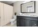 Clean bathroom with dark vanity and white toilet at 1716 22Nd N Ave, St Petersburg, FL 33713