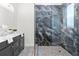Elegant bathroom with double vanity, large shower, and marble tile at 1716 22Nd N Ave, St Petersburg, FL 33713