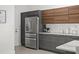 Modern kitchen with stainless steel refrigerator and gray cabinetry at 1716 22Nd N Ave, St Petersburg, FL 33713