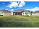 Large backyard with screened patio and lush lawn at 1847 Pacific Dunes Dr, Sun City Center, FL 33573