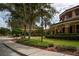 Partial view of clubhouse exterior with landscaping at 1847 Pacific Dunes Dr, Sun City Center, FL 33573