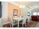 Elegant dining room with a white table and chairs, and an accent wall at 1847 Pacific Dunes Dr, Sun City Center, FL 33573