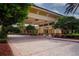 Clubhouse driveway entrance with covered walkway and landscaping at 1847 Pacific Dunes Dr, Sun City Center, FL 33573