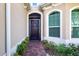 Front entry with decorative iron gate and brick walkway at 1847 Pacific Dunes Dr, Sun City Center, FL 33573