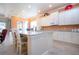 Kitchen island with seating and granite countertops at 1847 Pacific Dunes Dr, Sun City Center, FL 33573