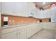 Spacious kitchen with white cabinets, granite countertops, and ample counter space at 1847 Pacific Dunes Dr, Sun City Center, FL 33573
