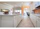 Spacious kitchen with granite countertops, white cabinets, and breakfast bar at 1847 Pacific Dunes Dr, Sun City Center, FL 33573